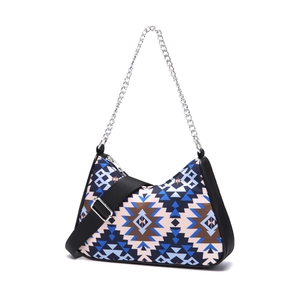 Close-up of bohemian aztec shoulder bag with metallic chain and wide woven strap