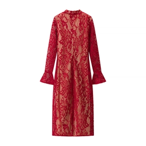 Detailed view of the red lace texture and floral hollow pattern on the trumpet sleeves