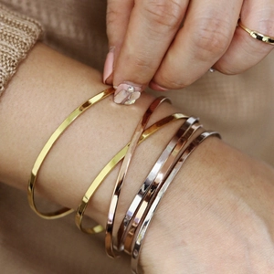 Minimalist stainless steel open bangles in gold, rose gold, and silver finishes