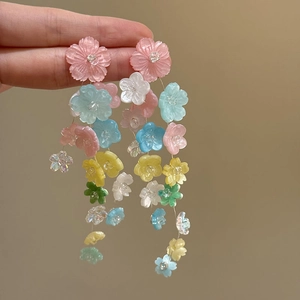 Detail of colorful resin flower tassel earrings with pink blue and green beads