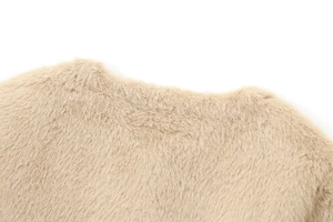 Close-up of soft light brown faux fur texture showing thick plush material on a jacket