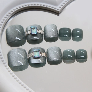 Gray cat eye press-on toenails with sparkling crystals on white pearl mirror surface