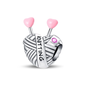 Detailed view of silver knitting yarn ball charm with pink heart pins and engraving