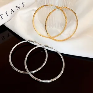 Chic hollow hoop earrings in gold and silver with frosted glitter finish for women