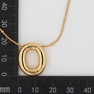 Macro shot of a gold-plated puffy oval pendant on a snake chain showing 22mm size scale