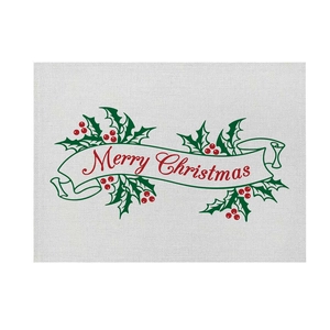 Detail of Christmas linen placemat with Merry Christmas print and holly leaf patterns