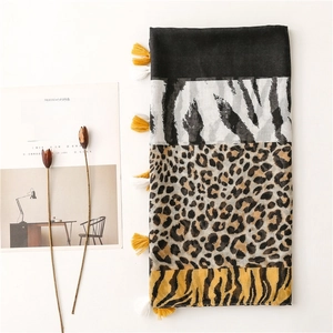 Zebra and leopard print patchwork scarf with cotton tassels on white background