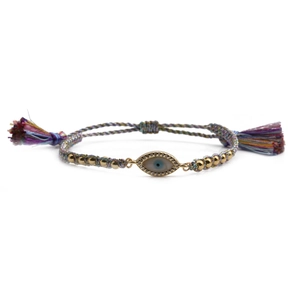 Detail of colorful woven Evil Eye bracelet with gold beads and silk tassels on white background