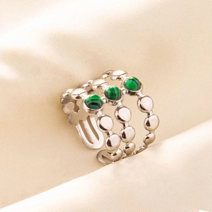 Macro shot of silver-toned vintage ring featuring three green round malachite stones