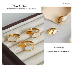Detail view of gold titanium ring with oval white mother of pearl inlay on velvet tray