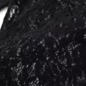 Detailed close-up showing the intricate floral lace texture and hollow patterns in black fabric