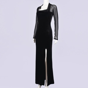 Detail of elegant black velvet dress with sheer mesh sleeves and sexy high side slit