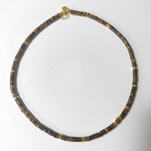 Detail of natural tiger eye stone disc beads with gold spacers and lobster clasp