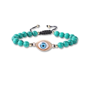 Detailed view of handmade woven evil eye bracelet with turquoise beads and adjustable cord