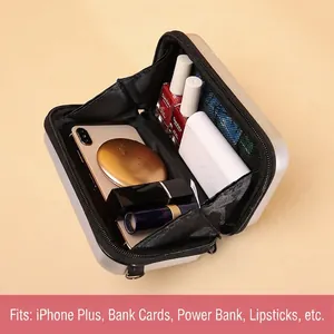 Mini silver hard shell suitcase crossbody bag showing internal storage for phone and makeup