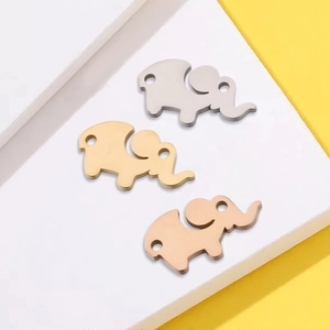 Three mirror-polished elephant pendants in silver, gold, and rose gold stainless steel
