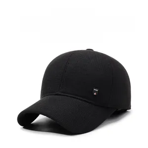 Close-up of black winter baseball cap with protective ear flaps and SPORT tag
