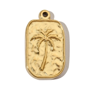 Close-up of gold plated palm tree pendant with hammered texture and rectangular shape