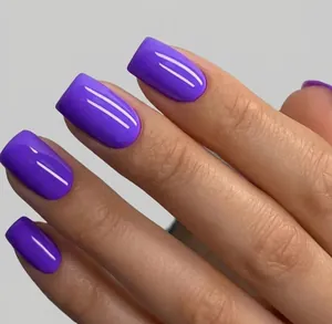 Close-up of glossy purple press-on nails with mirror finish in short square shape