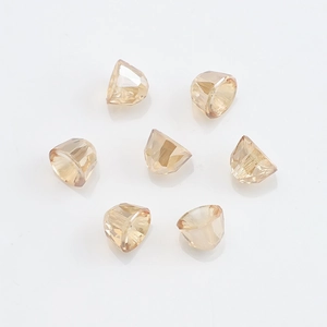 Detail shot of faceted light amber crystal glass bell pendants with multi-cut finish