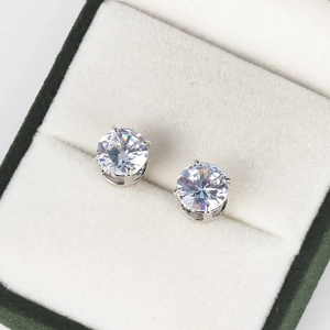 Close-up of sparkling round-cut cubic zirconia studs in four-claw silver setting on velvet box