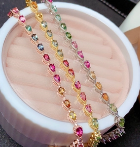 Detailed view of rainbow gemstone bracelets in rose gold, yellow gold, and silver finishes