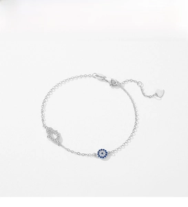 Detail of S925 sterling silver bracelet with evil eye and hand of Fatima charms