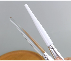 Close-up of two professional DIY mask brushes with transparent and solid white handles