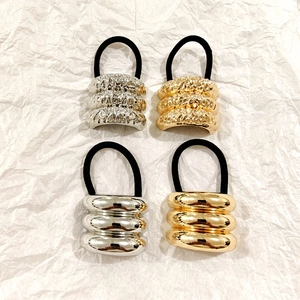 Set of 4 hollow metal hair ties in gold and silver finish with textured and smooth surfaces