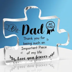 Macro shot of puzzle-shaped clear acrylic ornament with Dad Father's Day print