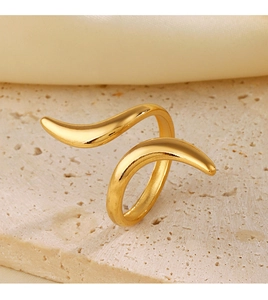 Macro detail of minimalist 18K gold plated stainless steel open ring on beige stone