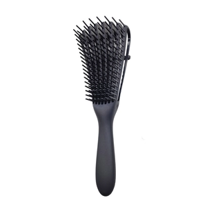 Detailed close-up of a black plastic vent brush with rounded massage tips and vent design