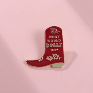 Detail of red cowboy boot enamel brooch featuring What Would Dolly Do text design