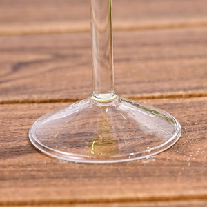 Macro view of the round glass base and stem detail of this creative cocktail glass