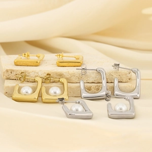 Macro shot of French vintage square pearl earrings in gold and silver finish