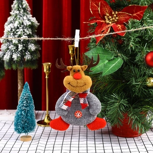 Close-up of a plush reindeer ornament with grey tweed clothes and a snowflake button