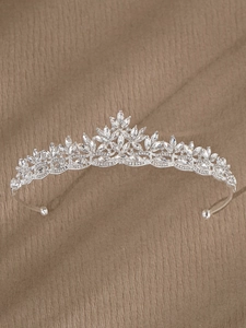 Detailed view of silver bridal tiara with leaf-patterned marquise rhinestones and side loops
