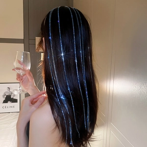 Detail of long blue crystal tassel hair chain with sparkling rhinestone fringes on hair