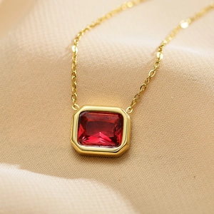 Elegant gold stainless steel necklace featuring a rectangular red zircon pendant on silk