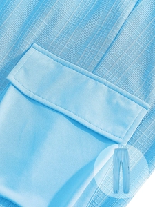 Detailed texture of light blue men's cargo pants with waffle fabric and side pockets