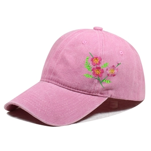 Pink washed cotton baseball cap with floral embroidery and classic curved brim style