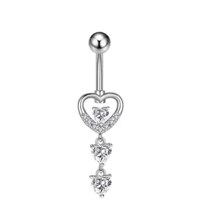 Detailed view of silver heart-shaped navel ring with sparkling zircon stone pendants