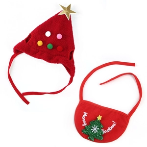 Flat lay of red plush Christmas tree pet hat and bib set with Merry Christmas text