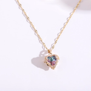 Close-up of heart-shaped iridescent gem pendant with sparkling pave zircon settings