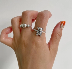 Detail of 925 sterling silver minimalist beaded ring and vintage bear design