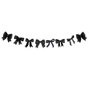 Detail of black bow garland with glitter and satin textures for party banner decorations