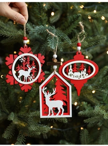 Detailed view of red and white wooden Christmas ornaments with snowflakes on a festive tree