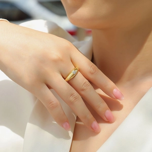 Close-up of minimalist gold plated S925 silver ring with a small round moissanite stone