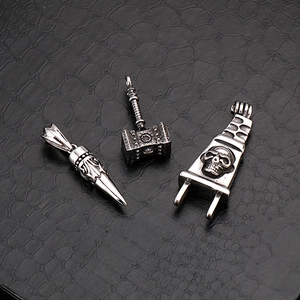 Vintage Thor's Hammer and skull cross steel pendants displayed on black leather