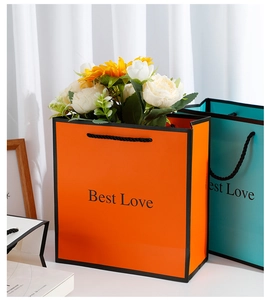 Medium size paper gift bag with sunflowers, white roses, and black cotton rope handle